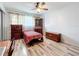 Bedroom with wooden furniture and a red and white striped bedspread at 8330 Vendome N Blvd # X, Pinellas Park, FL 33781