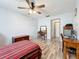 Bedroom with wooden furniture and a red and white striped bedspread at 8330 Vendome N Blvd, Pinellas Park, FL 33781