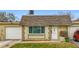 Front view of a single-story house with a garage and well-maintained lawn at 8330 Vendome N Blvd, Pinellas Park, FL 33781