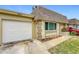 White garage door and light beige house exterior at 8330 Vendome N Blvd # X, Pinellas Park, FL 33781