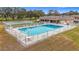 Community pool and recreation area with shuffleboard courts at 8330 Vendome N Blvd, Pinellas Park, FL 33781