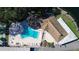 Aerial view of community pool, clubhouse, and surrounding landscape at 948 Virginia St # 110, Dunedin, FL 34698