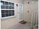 Condo entry with white door and screen door, next to window at 948 Virginia St # 110, Dunedin, FL 34698