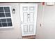 Condo entry with white door and screen door, next to window at 948 Virginia St # 110, Dunedin, FL 34698