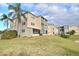 Condo building nestled on a grassy hill, additional building in background at 948 Virginia St # 110, Dunedin, FL 34698