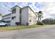 Two-story condo building with balconies and landscaping at 948 Virginia St # 110, Dunedin, FL 34698