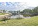 Landscaped pond with fountain in front of condo building at 948 Virginia St # 110, Dunedin, FL 34698