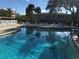 Inviting community pool with surrounding patio furniture at 948 Virginia St # 110, Dunedin, FL 34698