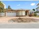 Tan house with white garage door and arched windows at 11325 9Th E St, Treasure Island, FL 33706