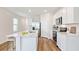 Modern kitchen with white cabinets, island, and stainless steel appliances at 12011 Lansing Gln, Parrish, FL 34219