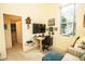 Home office features a desk, large window, and view of the bathroom at 1211 Lyndhurst Greens Dr, Sun City Center, FL 33573