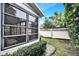 View of backyard with screened-in porch and white privacy fence at 13108 Dobree Pl, Riverview, FL 33579