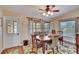 Bright dining room featuring a wooden table set, ceiling fan, and large windows with natural light at 13108 Dobree Pl, Riverview, FL 33579