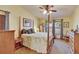 Bright bedroom featuring a four-poster bed and ample natural light at 13108 Dobree Pl, Riverview, FL 33579
