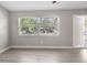 Bright living room with hardwood floors and large windows at 1349 Woodbine St, Clearwater, FL 33755