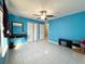 Spacious bedroom with light blue walls, tile floors, and double doors at 1447 Coble Rd, Spring Hill, FL 34608