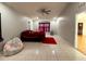 Bedroom with red bedding, a beanbag chair, and ceiling fan at 1447 Coble Rd, Spring Hill, FL 34608