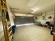 Attached garage with tiled floor and ample storage space at 1447 Coble Rd, Spring Hill, FL 34608