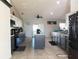 Modern kitchen with gray and white cabinets and an island at 1447 Coble Rd, Spring Hill, FL 34608