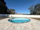 Inviting above ground pool with tiled patio and fence at 1447 Coble Rd, Spring Hill, FL 34608