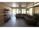 Sunroom features tiled floors, a sectional sofa, and pool view at 1447 Coble Rd, Spring Hill, FL 34608