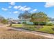 Two-home view showing a green exterior, yellow door, and a well-manicured lawn at 1685 Cambridge Dr, Clearwater, FL 33756