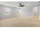 Primary bedroom with two windows, ceiling fan, and carpet at 17608 Glenapp Dr, Land O Lakes, FL 34638