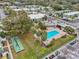 Aerial view of community pool, lawn, and building exteriors at 1799 N Highland Ave # 136, Clearwater, FL 33755