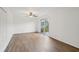 Simple bedroom with wood-look floors and sliding glass door to balcony at 1799 N Highland Ave # 136, Clearwater, FL 33755