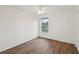 Simple bedroom with wood-look floors and a window at 1799 N Highland Ave # 136, Clearwater, FL 33755