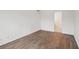 Simple bedroom with hardwood floors and access to bathroom at 1799 N Highland Ave # 136, Clearwater, FL 33755