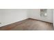Bedroom with wood-look floors and a window offering natural light at 1799 N Highland Ave # 136, Clearwater, FL 33755