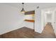 Small dining area with wood-look floors and a pass-through to kitchen at 1799 N Highland Ave # 136, Clearwater, FL 33755