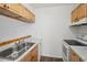 Efficient kitchen with light wood cabinets and stainless steel sink at 1799 N Highland Ave # 136, Clearwater, FL 33755