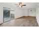 Bright living room with wood-look floors and sliding glass door to balcony at 1799 N Highland Ave # 136, Clearwater, FL 33755