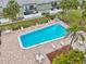 Community pool with surrounding patio furniture at 1799 N Highland Ave # 136, Clearwater, FL 33755