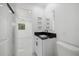 Modern bathroom with black and white vanity, walk-in shower, and toilet at 18292 Robinson Ave, Port Charlotte, FL 33948