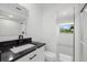 Updated bathroom features a black marble vanity and a shower/tub combo at 18292 Robinson Ave, Port Charlotte, FL 33948