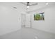 Bright bedroom with ceiling fan and access to the hallway at 18292 Robinson Ave, Port Charlotte, FL 33948