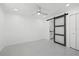 Spacious bedroom with a barn door and ceiling fan at 18292 Robinson Ave, Port Charlotte, FL 33948