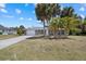 House exterior features a gray color and palm trees at 18292 Robinson Ave, Port Charlotte, FL 33948