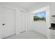 Bright kitchen features white cabinets and a window with a view at 18292 Robinson Ave, Port Charlotte, FL 33948