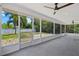 Large screened porch with ceiling fans and backyard access at 18292 Robinson Ave, Port Charlotte, FL 33948