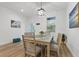 Bright dining room with a light wood table and six chairs at 18400 Tulane Ave, Port Charlotte, FL 33954