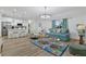 Open concept living room with light teal sofa and decorative rug at 18400 Tulane Ave, Port Charlotte, FL 33954