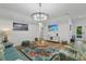 Bright living room with comfy seating, stylish rug, and large TV at 18400 Tulane Ave, Port Charlotte, FL 33954