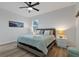 Spacious main bedroom with ceiling fan and en-suite bathroom at 18400 Tulane Ave, Port Charlotte, FL 33954