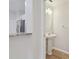 Modern bathroom with pedestal sink, updated vanity, and stylish mirror at 18924 Duquesne Dr, Tampa, FL 33647