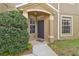 Townhome entry with dark gray door and landscaping at 18924 Duquesne Dr, Tampa, FL 33647