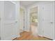 Bright hallway with hardwood floors and white doors at 18924 Duquesne Dr, Tampa, FL 33647